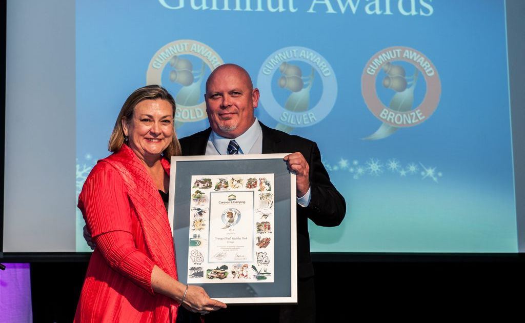 CCIA CEO Lyndal Gray presenting Silver Gumnut award to Brad Shiels representing the Urunga Heads Holiday Park. CCIA CEO Lyndal Gray presenting Silver Gumnut award to Brad Shiels representing the Urunga Heads Holiday Park.